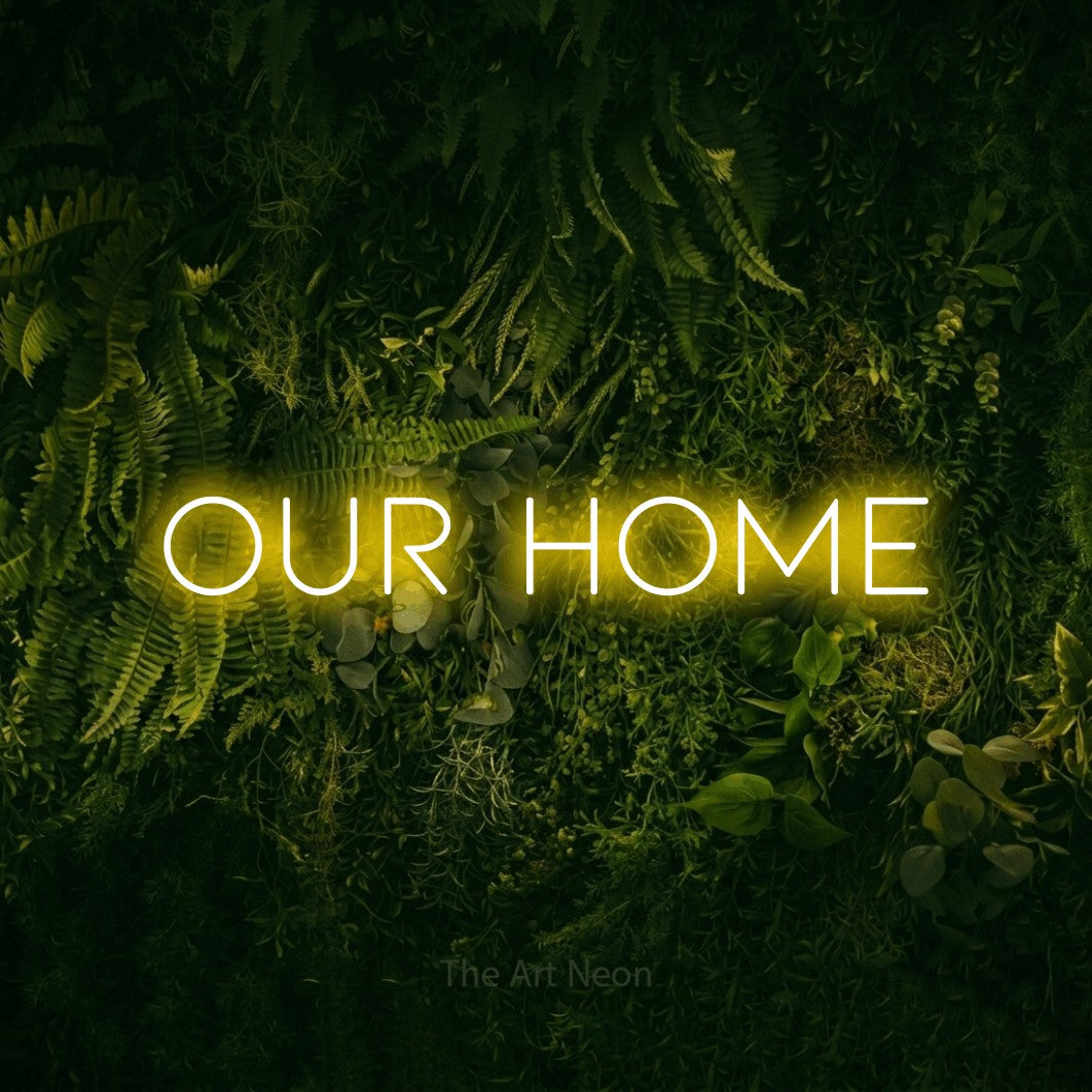 Yellow LED neon sign reading "Our Home" against a moss-covered green wall for living room décor