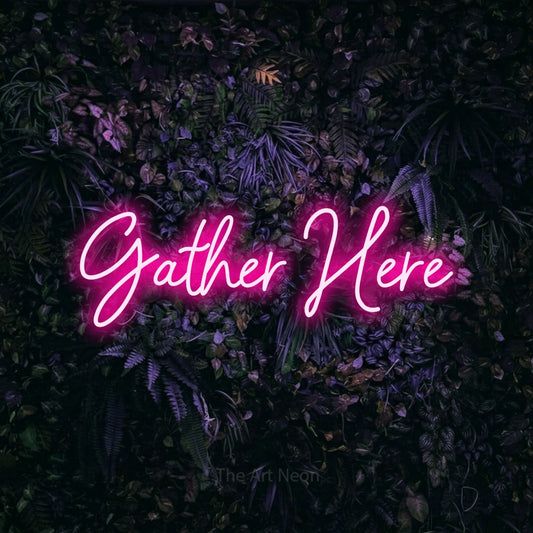 Hot pink script-style LED neon sign reading "Gather Here" against a purple floral wall for living room décor