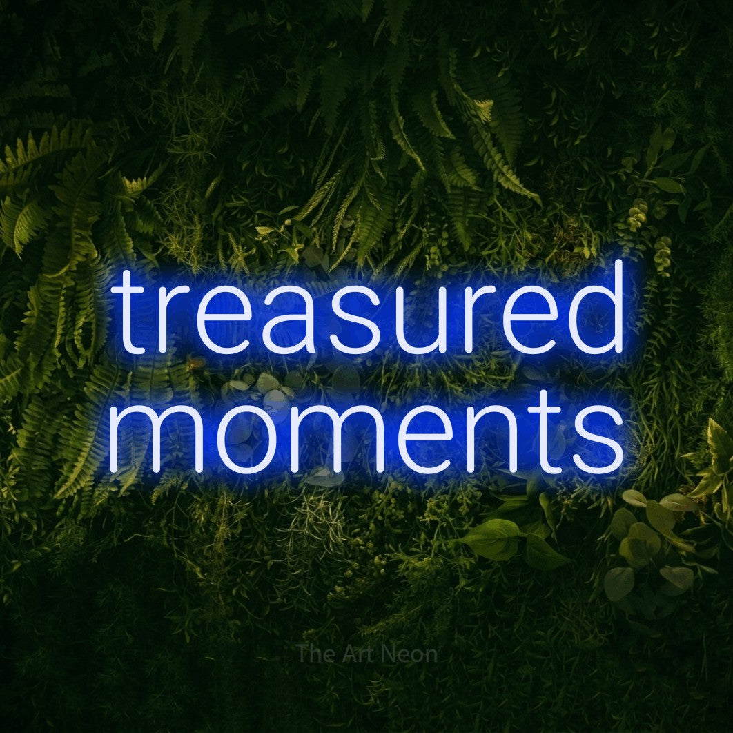 Blue LED neon sign reading "Treasured Moments" against a moss-covered green wall for living room décor