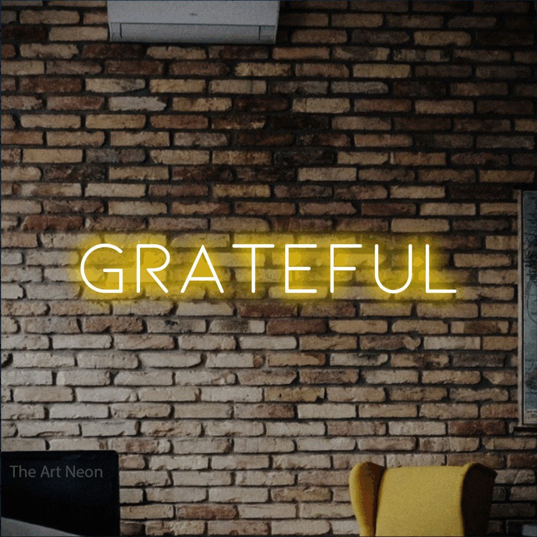 Yellow LED neon sign reading "Grateful" against a rustic brick wall for living room décor