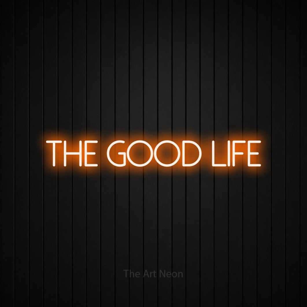 Orange LED neon sign reading "The Good Life" against a black vertical slat wall for living room décor