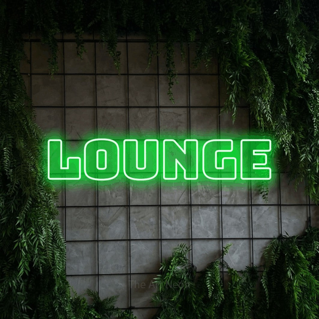 Green outline-style LED neon sign reading "Lounge" against a green grid wall with foliage for living room décor