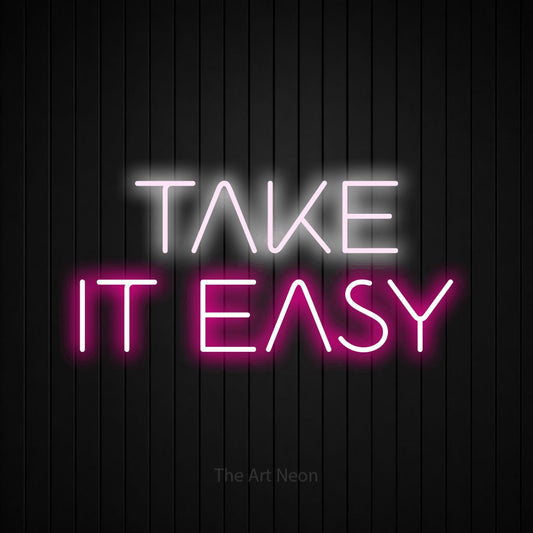 Hot pink and cool white LED neon sign reading "Take It Easy" against a black vertical slat wall for living room décor