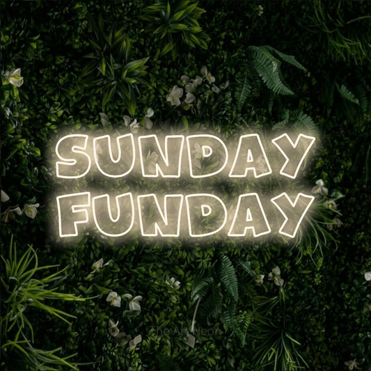 Warm white outline-style LED neon sign reading "Sunday Funday" against a leafy green wall for living room décor