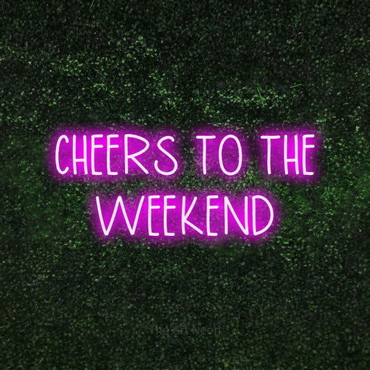 Pink LED neon sign reading "Cheers to the Weekend" against a textured green moss wall for living room décor