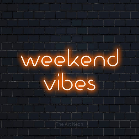 Orange LED neon sign reading "Weekend Vibes" against a dark navy brick wall for living room décor