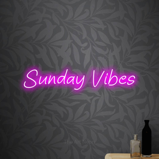 Pink LED neon sign reading "Sunday Vibes" against light grey floral wallpaper for living room décor