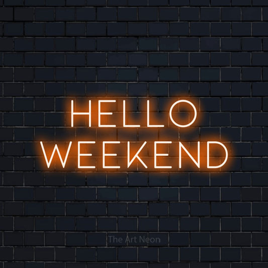 Orange LED neon sign reading "Hello Weekend" against a dark navy brick wall for living room décor