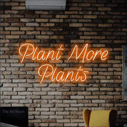 Orange LED neon sign reading "Plant More Plants" against a rustic brick wall for living room décor