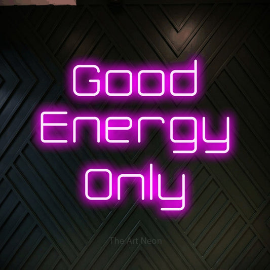 Pink LED neon sign reading "Good Energy Only" against a dark geometric wood wall for living room décor