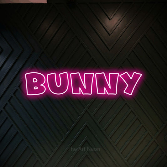 Enseigne néon à DEL à lumière rose vif, de style contour, affichant « Bunny » sur un mur géométrique en bois foncé, pour décorer une chambre de bébé