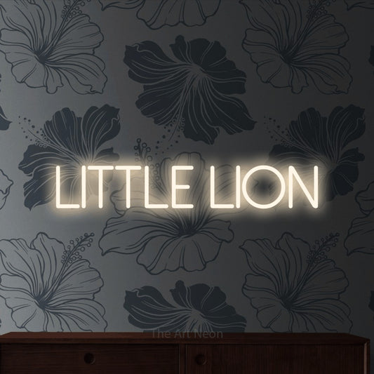Warm white LED neon sign reading "Little Lion" against grey floral wallpaper for nursery décor
