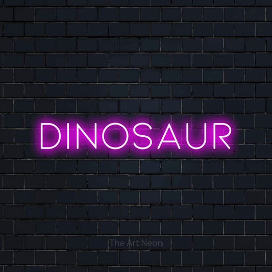 Pink LED neon sign reading "Dinosaur" against a dark navy brick wall for nursery décor