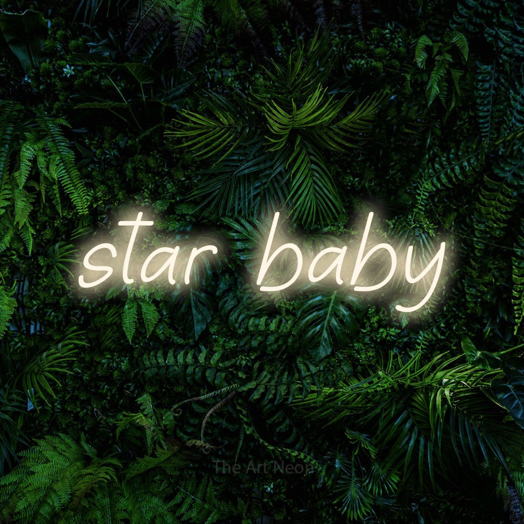 Warm white LED neon sign reading "Star Baby" against a dense tropical foliage wall for nursery décor