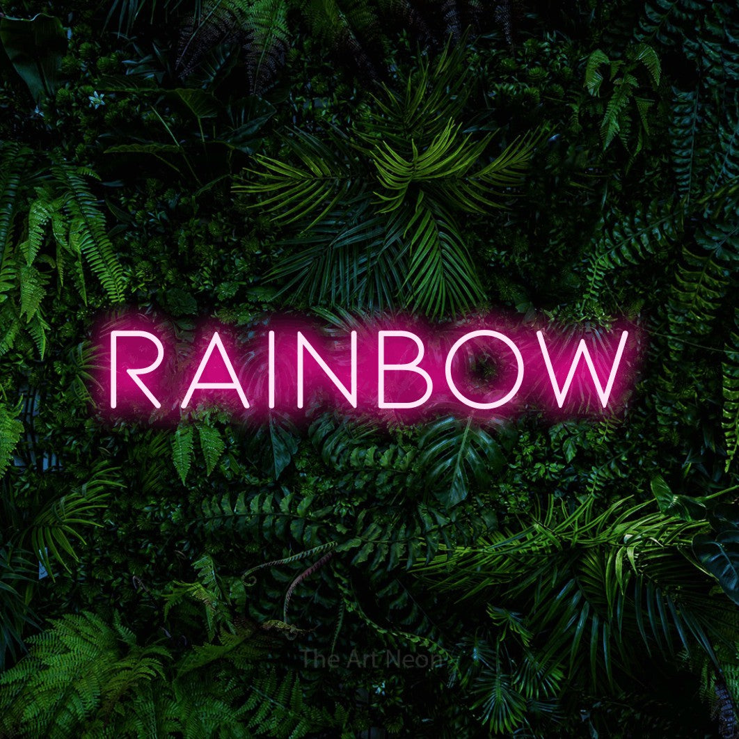 Hot pink LED neon sign reading "Rainbow" against a dense tropical foliage wall for nursery décor