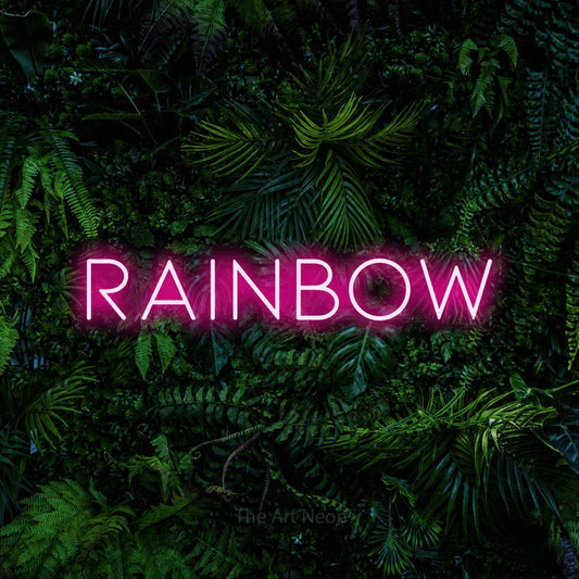Hot pink LED neon sign reading "Rainbow" against a dense tropical foliage wall for nursery décor