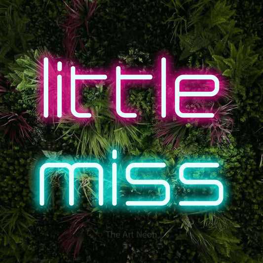 Ice blue and hot pink LED neon sign reading "Little Miss" against a lush garden wall with pink flowers for nursery décor