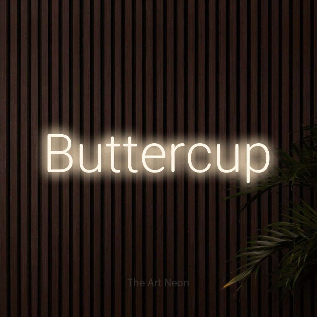Warm white LED neon sign reading "Buttercup" against dark wooden slats for nursery décor