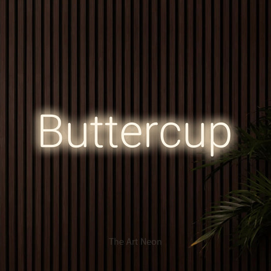 Warm white LED neon sign reading "Buttercup" against dark wooden slats for nursery décor