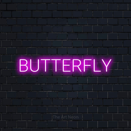 Pink LED neon sign reading "Butterfly" against a dark navy brick wall for nursery décor