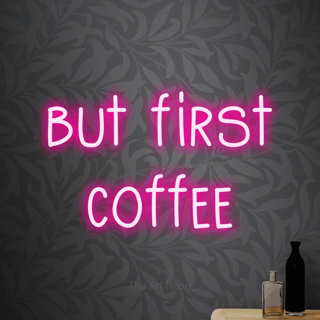 Hot pink LED neon sign reading "But First Coffee" against light grey floral wallpaper for kitchen décor