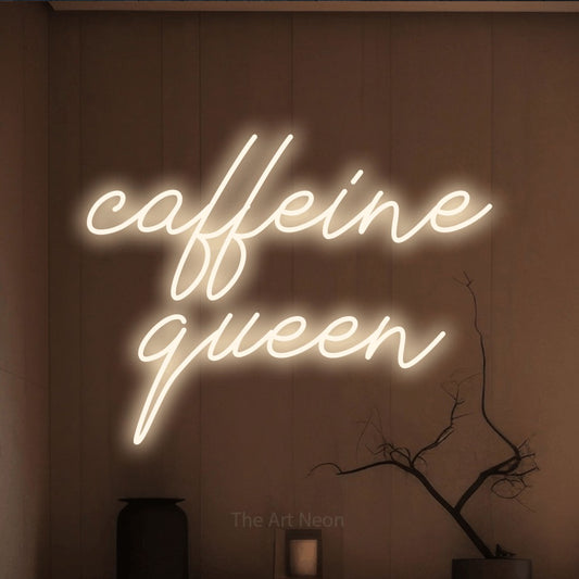 Warm white script-style LED neon sign reading "Caffeine Queen" against a warm brown wall for kitchen décor
