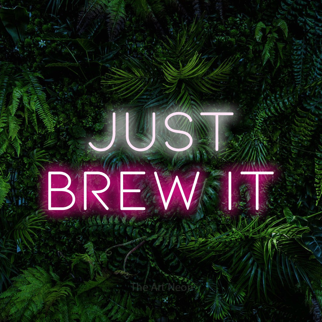 Hot pink and cool white LED neon sign reading "Just Brew It" against a dense tropical foliage wall for kitchen décor