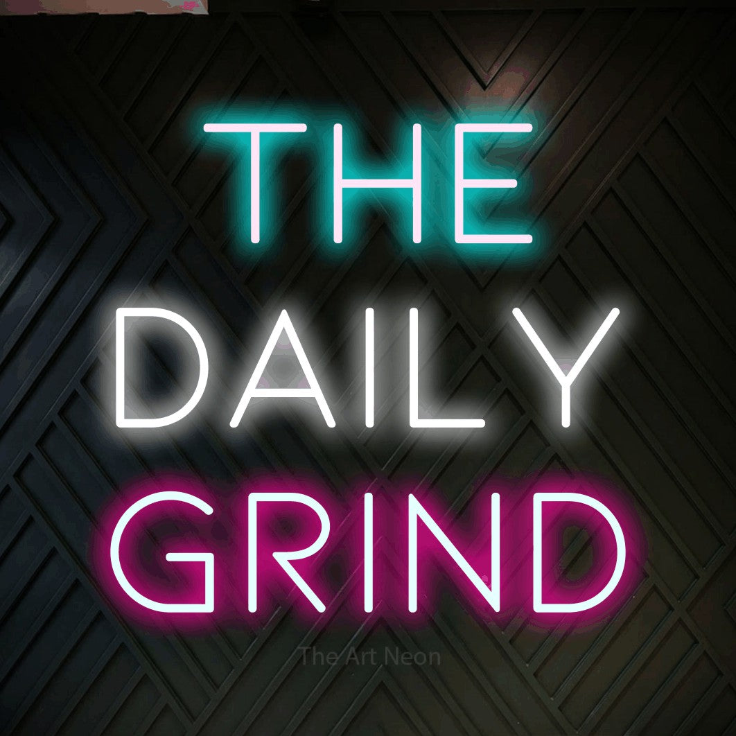 Multicolour LED neon sign reading "The Daily Grind" against a dark geometric wood wall for kitchen décor
