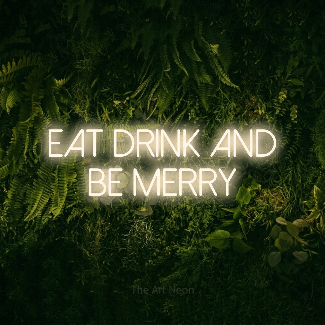 Warm white LED neon sign reading "Eat Drink and Be Merry" against a moss-covered green wall for kitchen décor