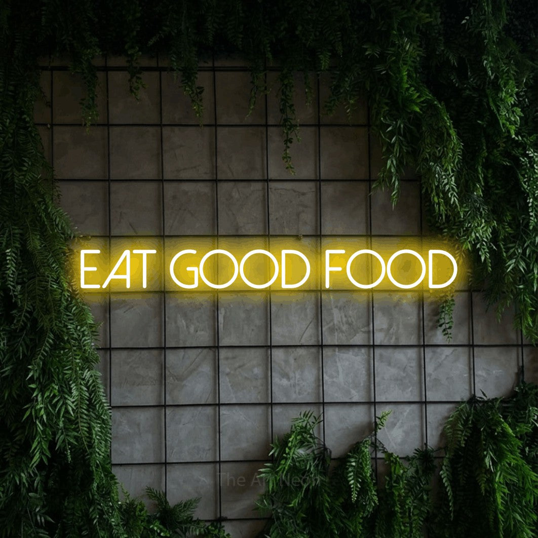 Enseigne néon à DEL à lumière jaune, affichant « Eat Good Food » sur un mur quadrillé vert avec du feuillage, pour décorer une cuisine