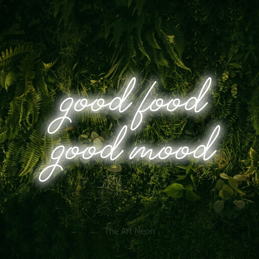 Cool white script-style LED neon sign reading "Good Food Good Mood" against a moss-covered green wall for kitchen décor