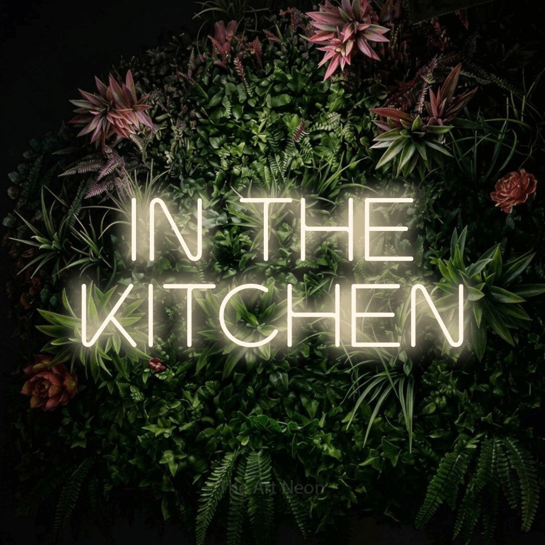 Warm white LED neon sign reading "In the Kitchen" against a flowering garden wall for kitchen décor