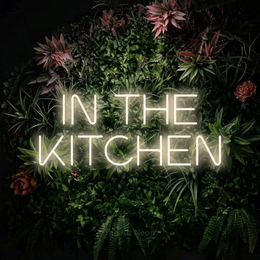 Warm white LED neon sign reading "In the Kitchen" against a flowering garden wall for kitchen décor