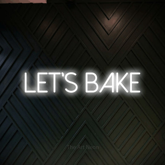 Cool white LED neon sign reading "Let's Bake" against a dark geometric wood wall for kitchen décor