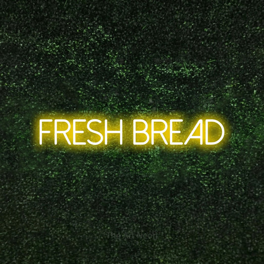 Yellow LED neon sign reading "Fresh Bread" against a textured green moss wall for kitchen décor