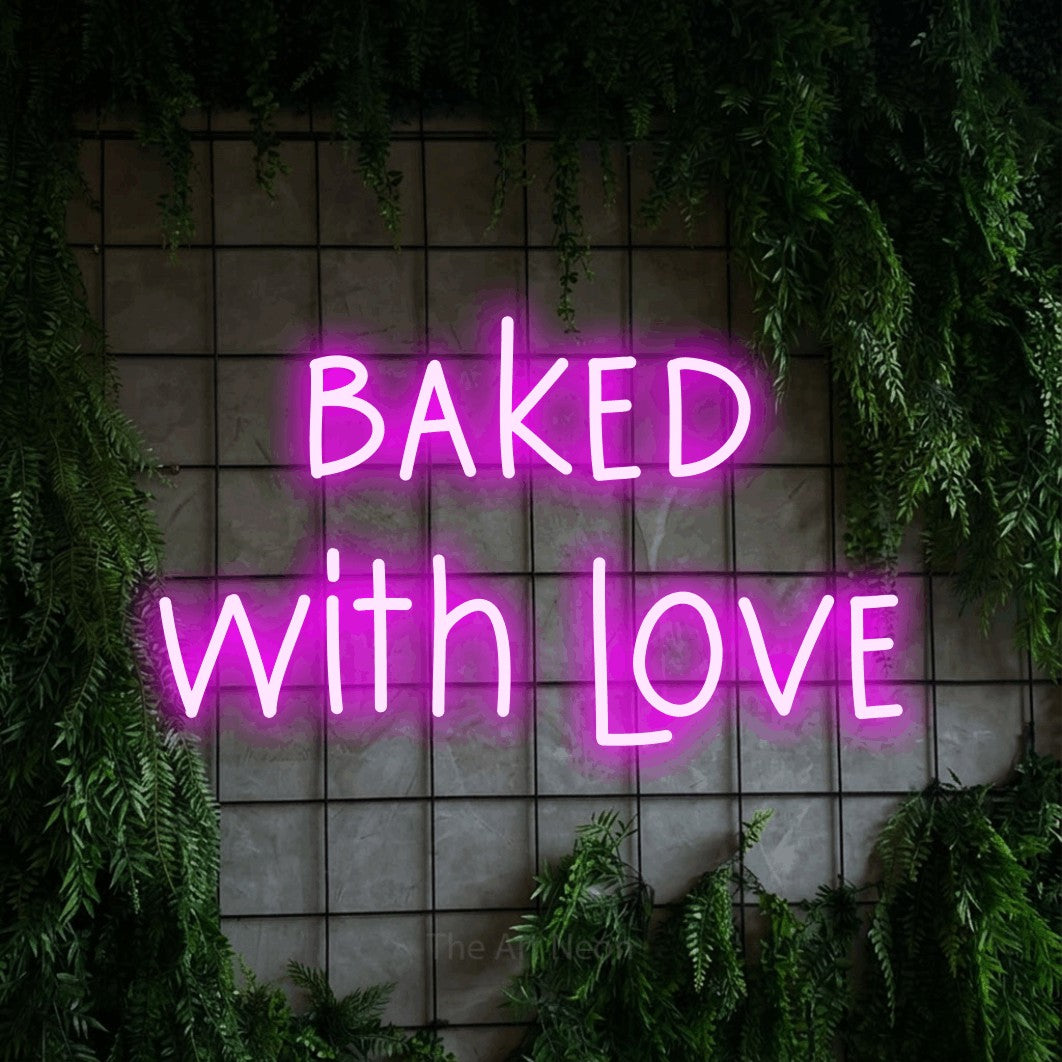 Enseigne néon à DEL à lumière rose, affichant « Baked with Love » sur un mur quadrillé vert avec du feuillage, pour décorer une cuisine