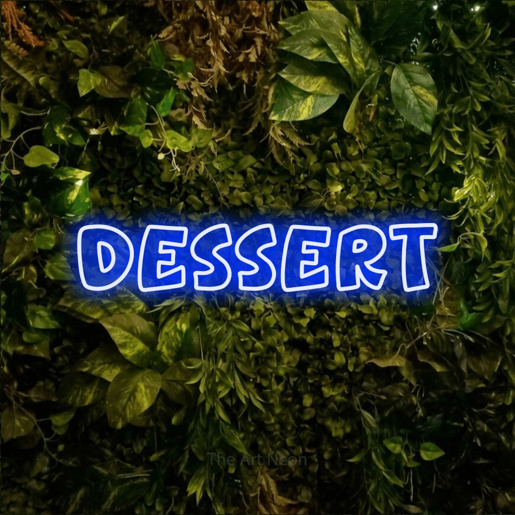 Blue outline-style LED neon sign reading "Dessert" against a textured moss and foliage wall for kitchen décor