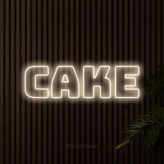 Warm white outline-style LED neon sign reading "Cake" against dark wooden slats for kitchen décor