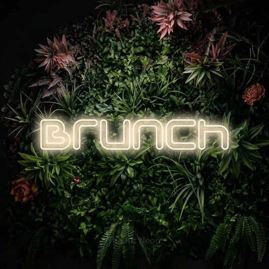 Warm white outline-style LED neon sign reading "Brunch" against a flowering garden wall for kitchen décor