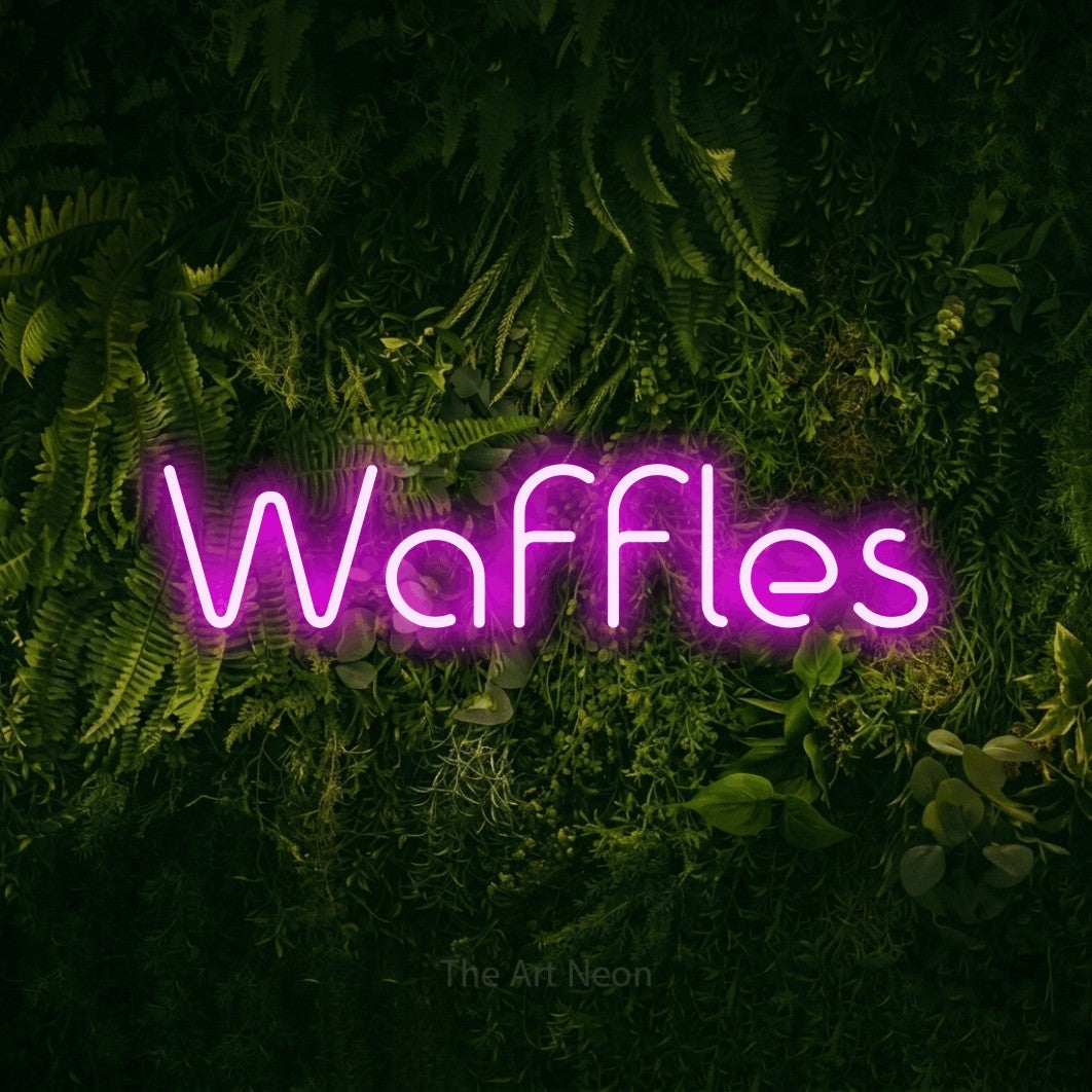 Pink LED neon sign reading "Waffles" against a moss-covered green wall for kitchen décor
