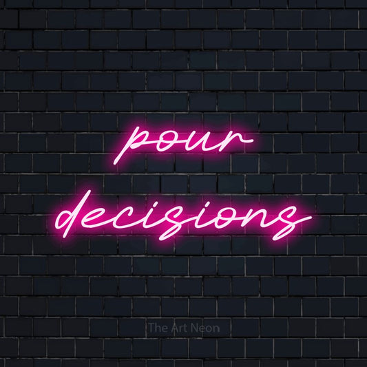 Hot pink LED neon sign reading "Pour Decisions" against a dark navy brick wall for kitchen décor
