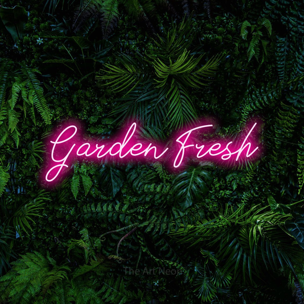 Hot pink script-style LED neon sign reading "Garden Fresh" against a dense tropical foliage wall for kitchen décor