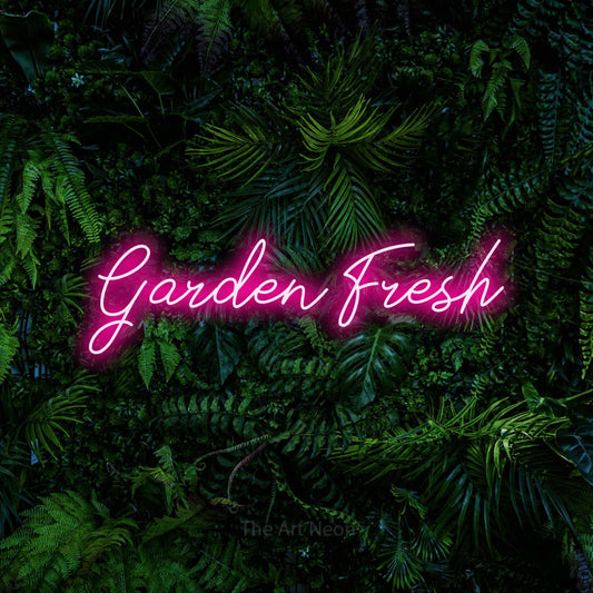 Hot pink script-style LED neon sign reading "Garden Fresh" against a dense tropical foliage wall for kitchen décor