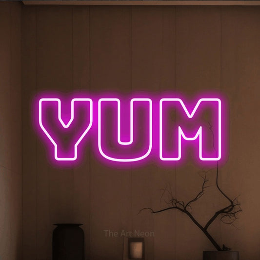 Pink outline-style LED neon sign reading "Yum" against a warm brown wall for kitchen décor