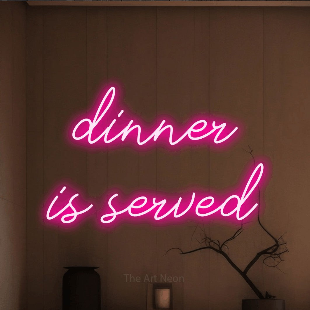 Hot pink script-style LED neon sign reading "Dinner is Served" against a warm brown wall for kitchen décor