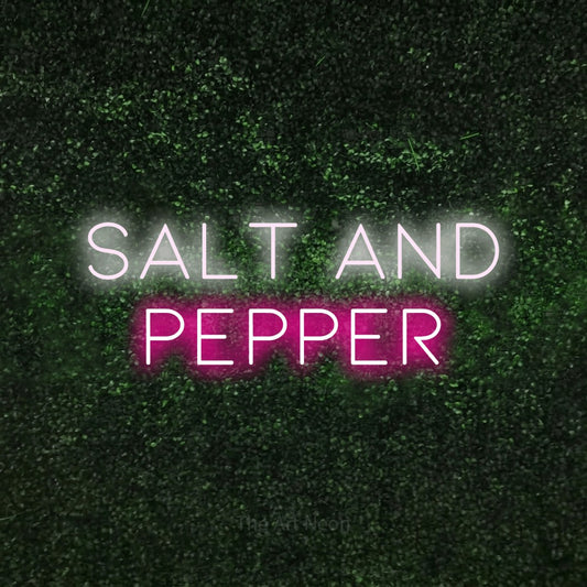 Hot pink and cool white LED neon sign reading "Salt and Pepper" against a textured green moss wall for kitchen décor