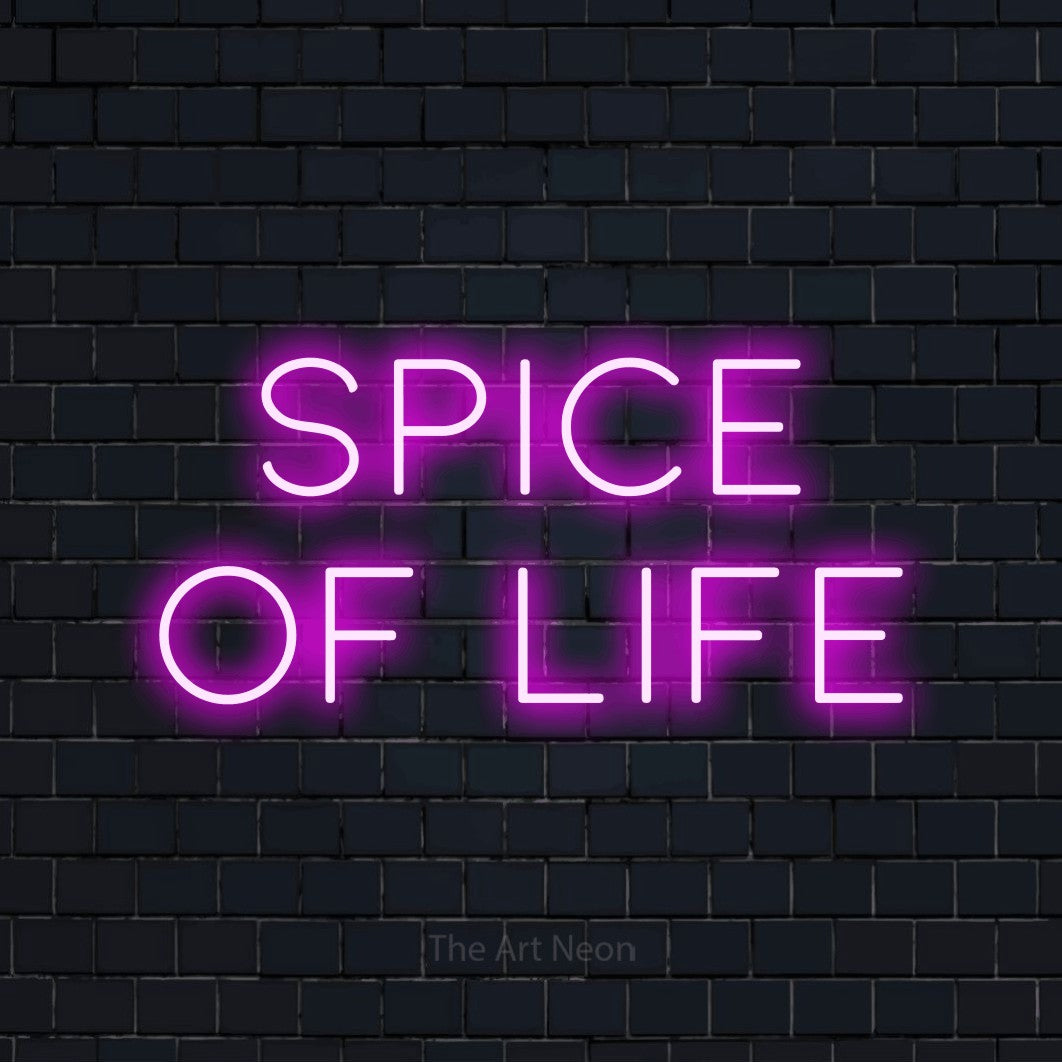 Pink LED neon sign reading "Spice of Life" against a dark navy brick wall for kitchen décor