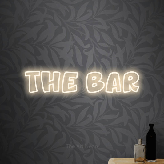 Warm white outline-style LED neon sign reading "The Bar" against light grey floral wallpaper for bar décor