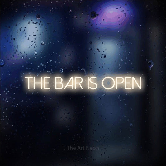 Warm white LED neon sign reading "The Bar is Open" against a dark blue bokeh background for bar décor