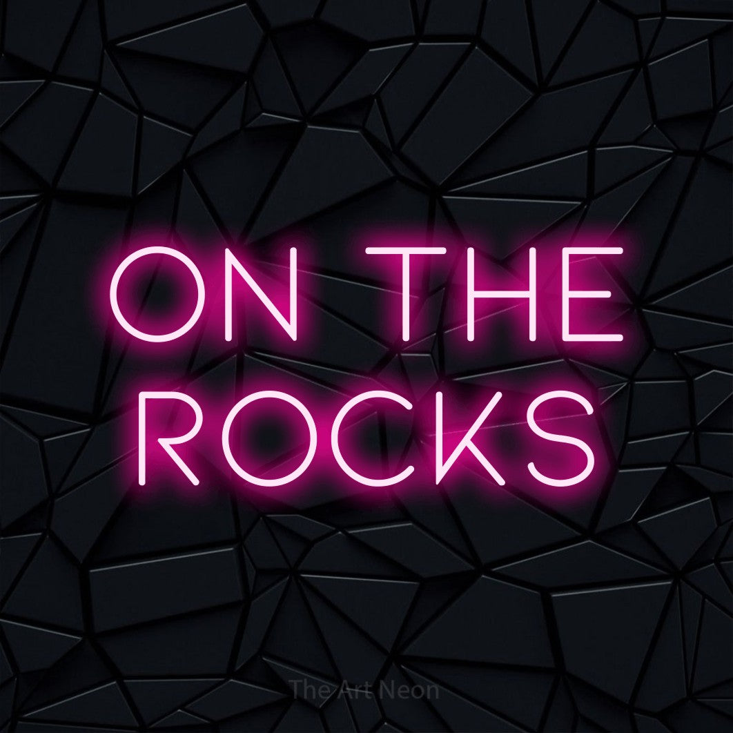 Hot pink LED neon sign reading "On the Rocks" against a black faceted wall for bar décor